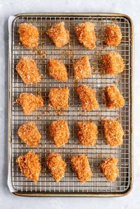 Estes são os MELHORES nuggets de frango caseiros assados ​​e crocantes que você vai fazer! Adequado para crianças e aprovado para adultos!