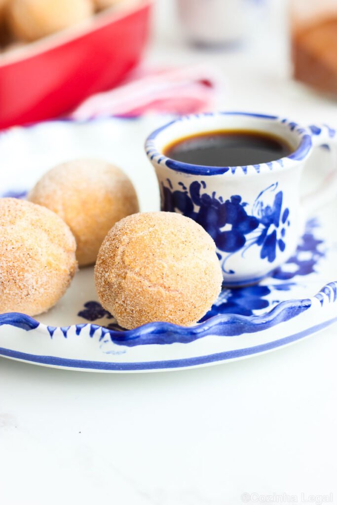 Crocante por fora e supermacio por dentro, esse bolinho de chuva foge da receita tradicional logo no primeiro ingrediente: aqui não entra farinha de trigo, e também não entra leite. No lugar dos dois, o polvilho doce assume o comando e entrega uma massa que parece impossível até você experimentar.